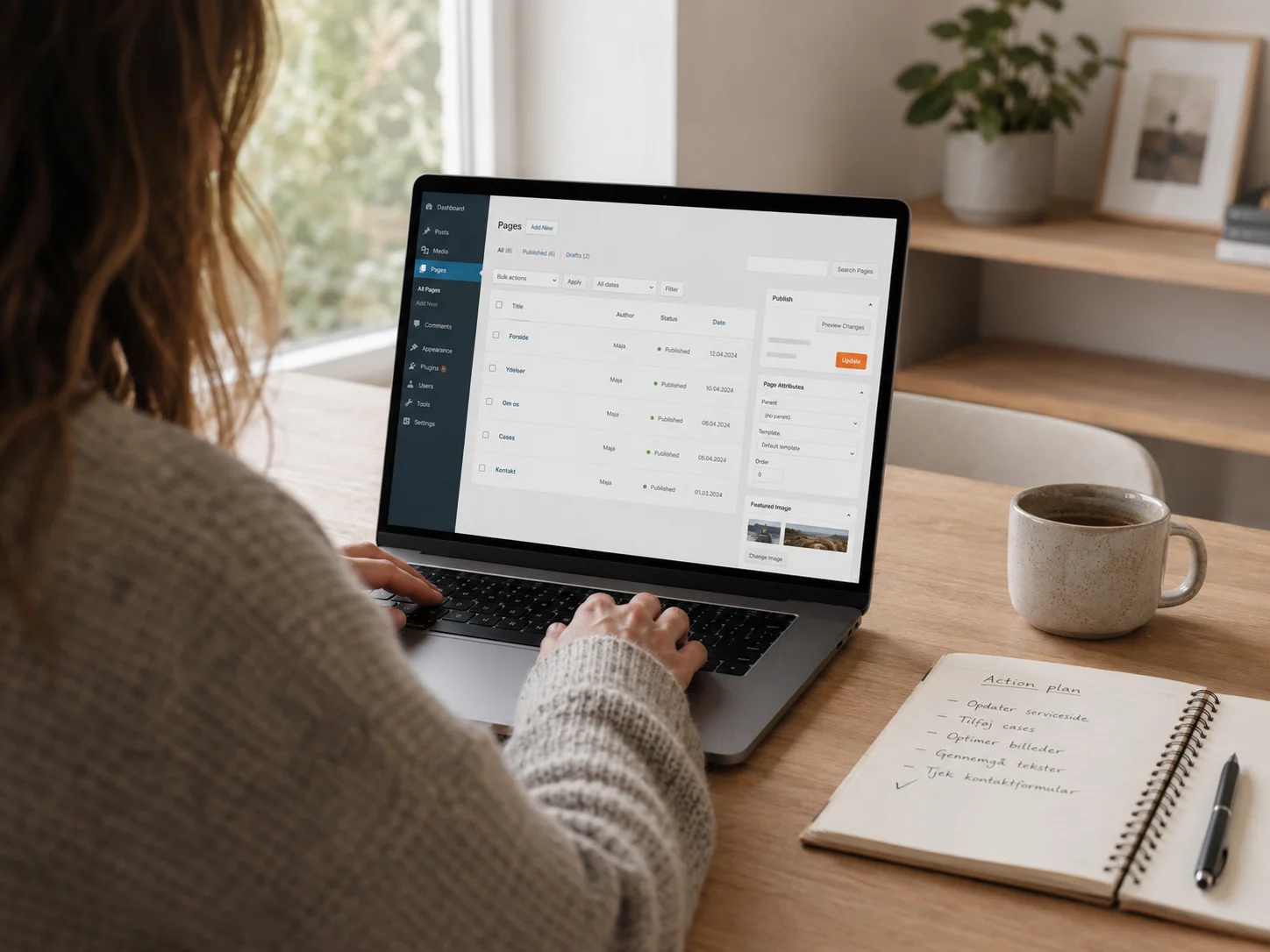 Person arbejder i WordPress-lignende dashboard med notesbog og handlingsplan på skrivebordet